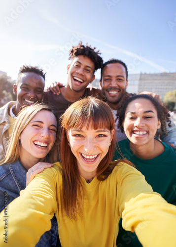 Group of happy friends posing for a selfie on a spring day as they party together outdoors. Group of multicultural friends having a good time together on the weekend.