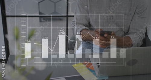 Image of diagrams and data processing over biracial businessman using smartphone