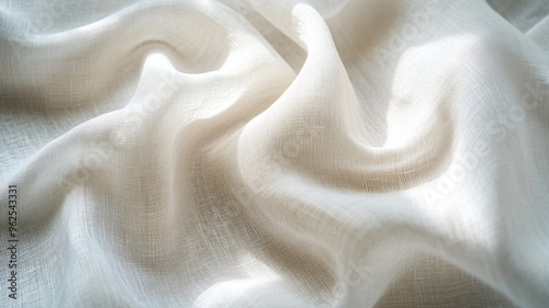 Soft white fabric draping elegantly in natural light showcases texture and movement