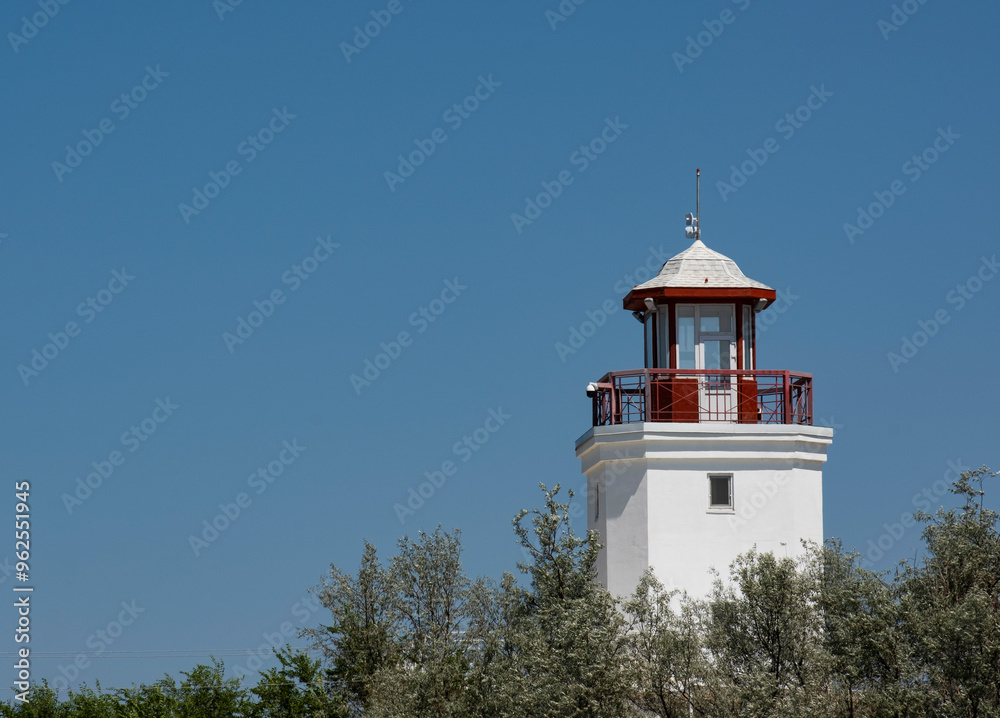 The building of the white lighthouse against the sky. The building of the white lighthouse against the sky.