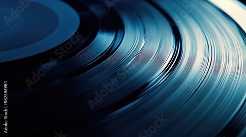 A close-up of a vinyl record spinning, with the grooves creating circular lines under soft, ambient lighting