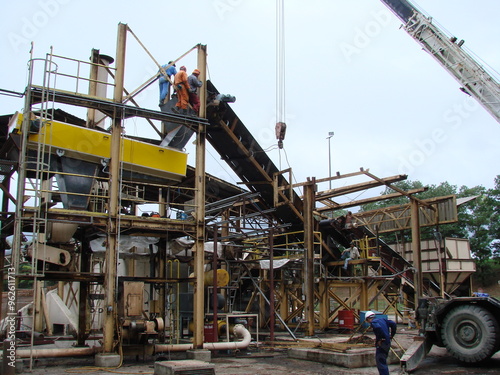 Bintulu, Malaysia - November 8, 2006: The machineries, equipment, production line, working conditions and general view of the manufacturing environment within a Medium Density Fiberboard factory and p photo