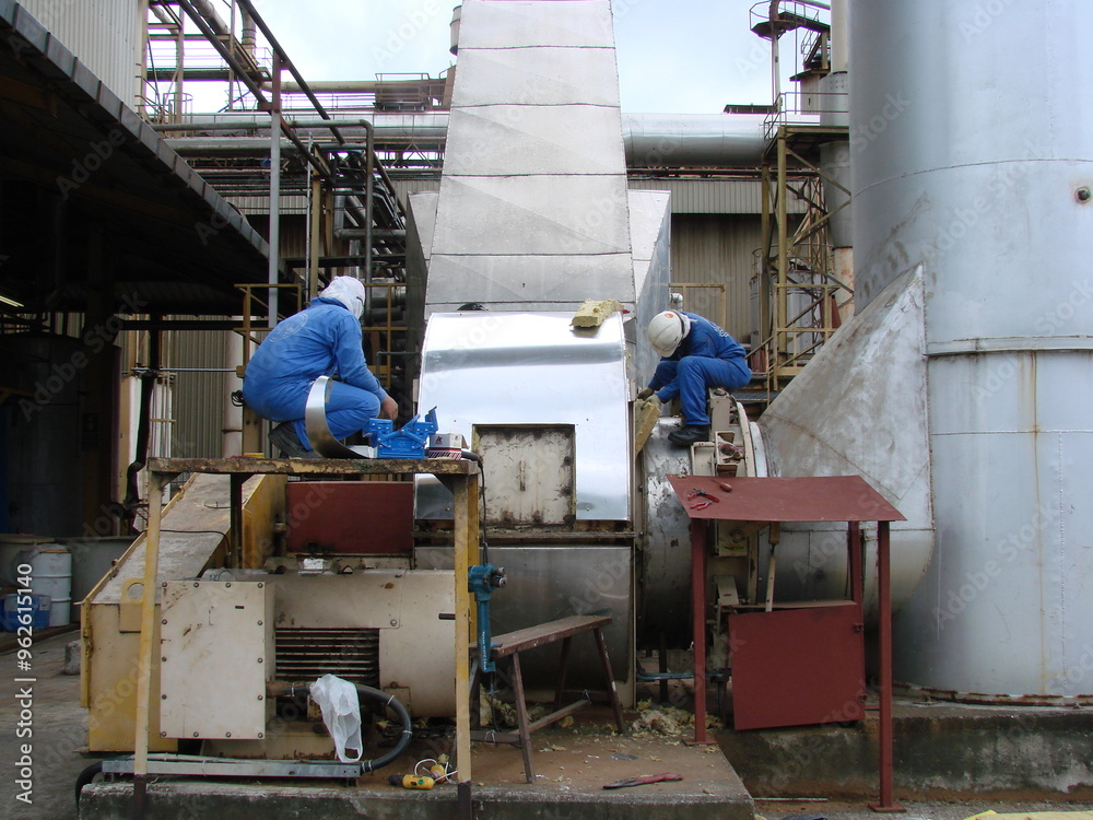 Bintulu, Malaysia - November 8, 2006: The machineries, equipment, production line, working conditions and general view of the manufacturing environment within a Medium Density Fiberboard factory and p