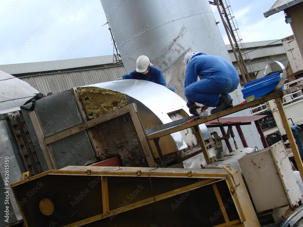 Bintulu, Malaysia - November 8, 2006: The machineries, equipment, production line, working conditions and general view of the manufacturing environment within a Medium Density Fiberboard factory and p