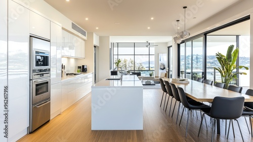 White interior kitchen with a sleek design, integrated appliances, and a large island for family gatherings