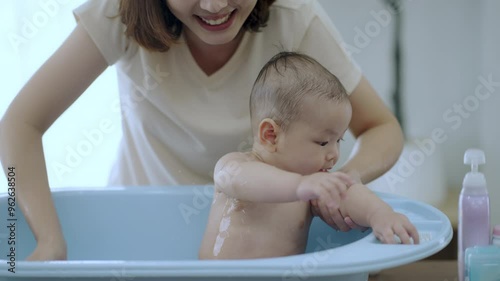 Young mom shower baby , Baby asian happy moment with mom at living room. asian family with newborn