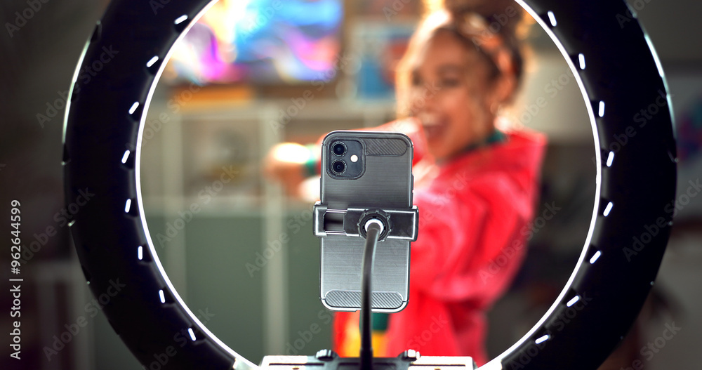 © HockleyM3/peopleimages.com - Happy woman, influencer and phone with ring light for video recording, online tutorial or communication at home. Young, female person or vlogger with mobile smartphone for dance or content creation