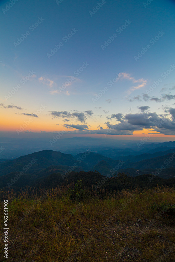 Obraz premium Colorful sky sunset on peak of mountain tropical forest