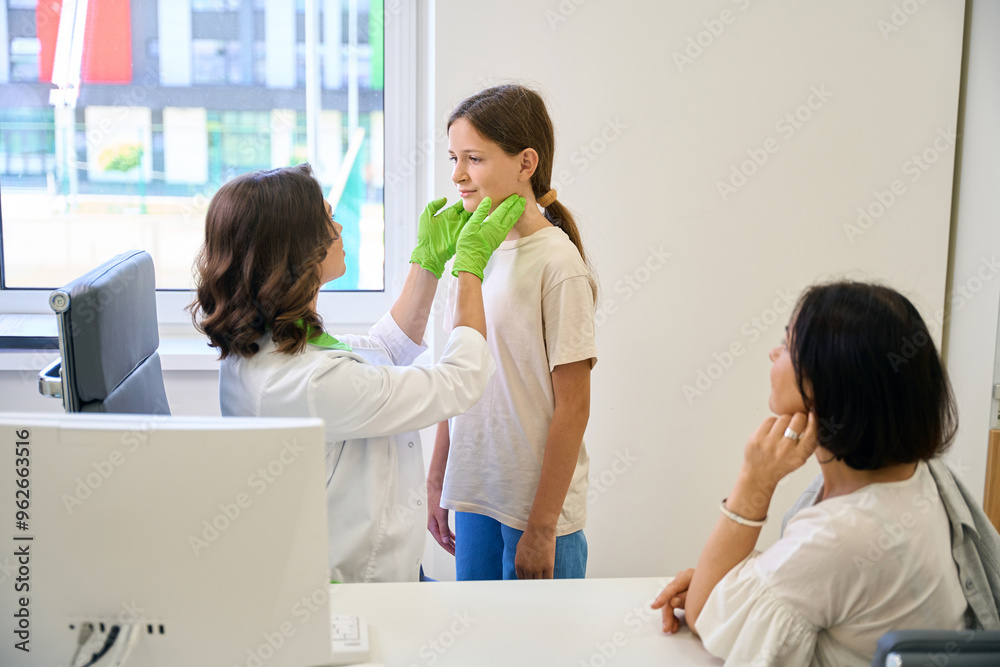 Home doctor examines the throat of a teenage girl Home doctor examines the throat of a teenage girl