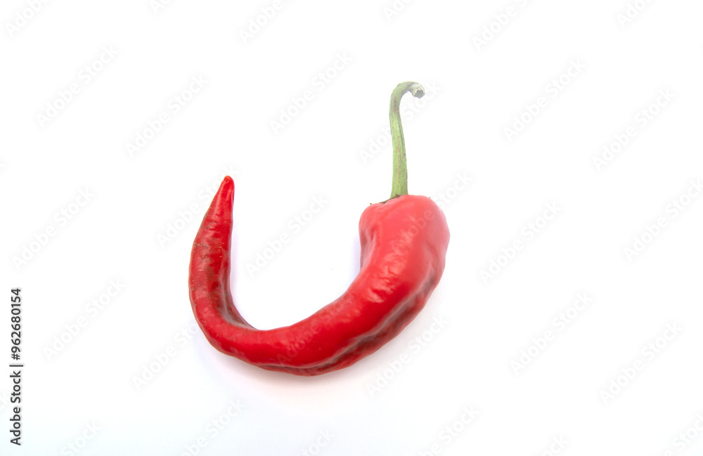 A red pepper is shown with its stem and the stem is bent A red pepper is shown with its stem and the stem is bent
