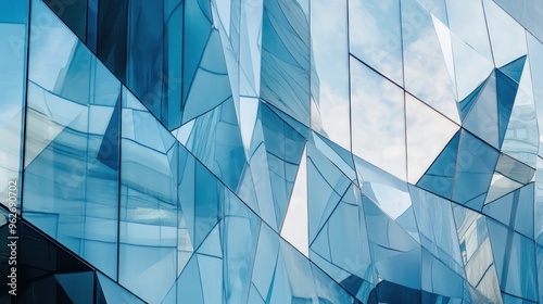 Abstract reflection of a modern building's glass facade with angular shapes and textures.