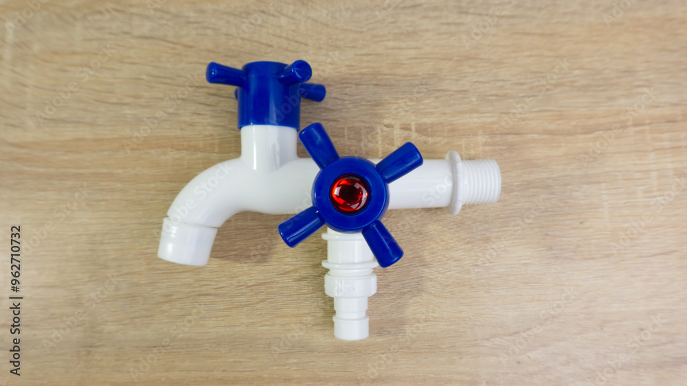 Plastic faucet tap water on wooden table
Plastic faucet tap water on wooden table