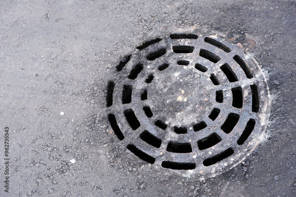 round grate for draining waste water, drainage, rolled into asphalt