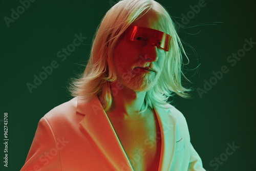 Futuristic man with long silver hair wearing red tinted glasses in a stylish outfit, set against a vibrant green background for a striking visual concept