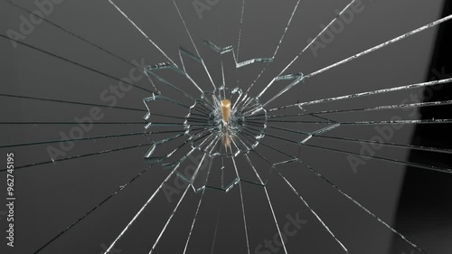 Smooth Slowmotion Shot Of A Bullet Shattering Glass With Fragments Flying