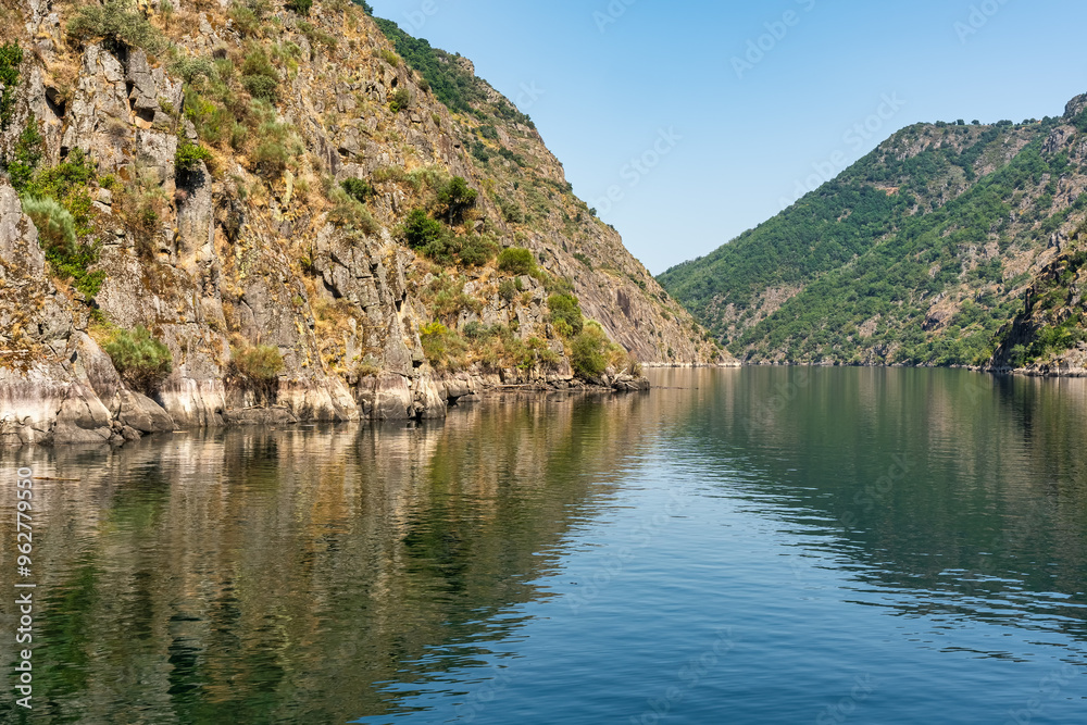 Cliffs of the Sil River canyon with grape vines on its slopes to produce a highly appreciated wine, Ribeira Sacra. Cliffs of the Sil River canyon with grape vines on its slopes to produce a highly appreciated wine, Ribeira Sacra.