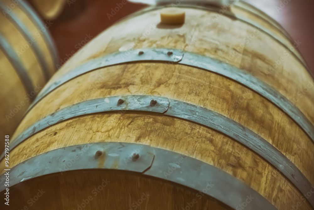 oak barrel with iron hoops for storing wine and sherry close-up oak barrel with iron hoops for storing wine and sherry close-up