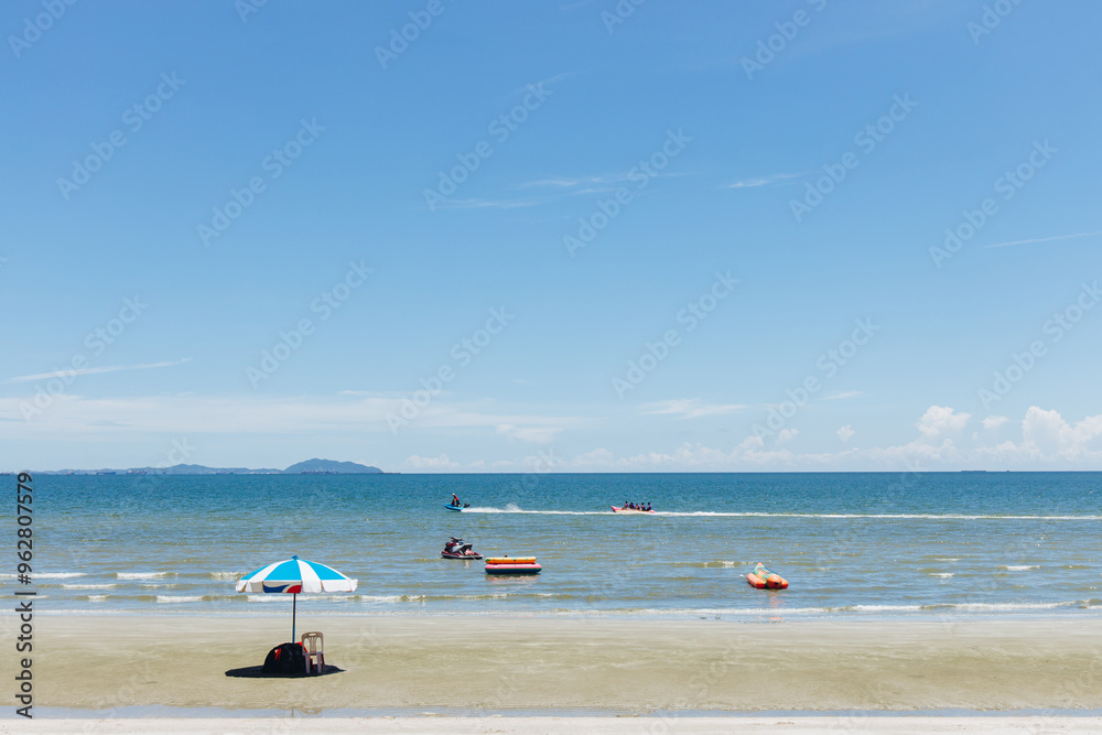 Beach sea space area. Beautiful tropical beach and Inflatable boat with blue sky and white clouds in sunny day Beach sea space area. Beautiful tropical beach and Inflatable boat with blue sky and white clouds in sunny day