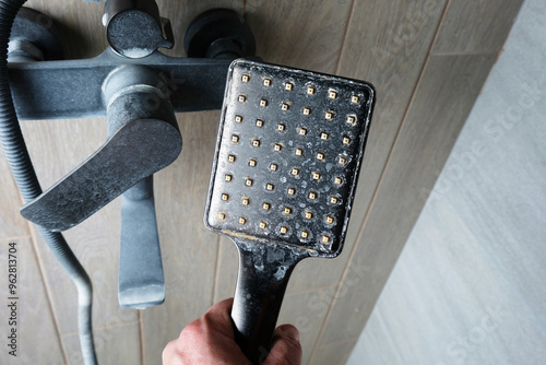 Limescale on shower head close-up, plumbing maintenance concept, silicone nozzles,hard water