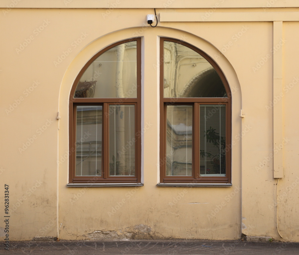 A large arched window divided into two