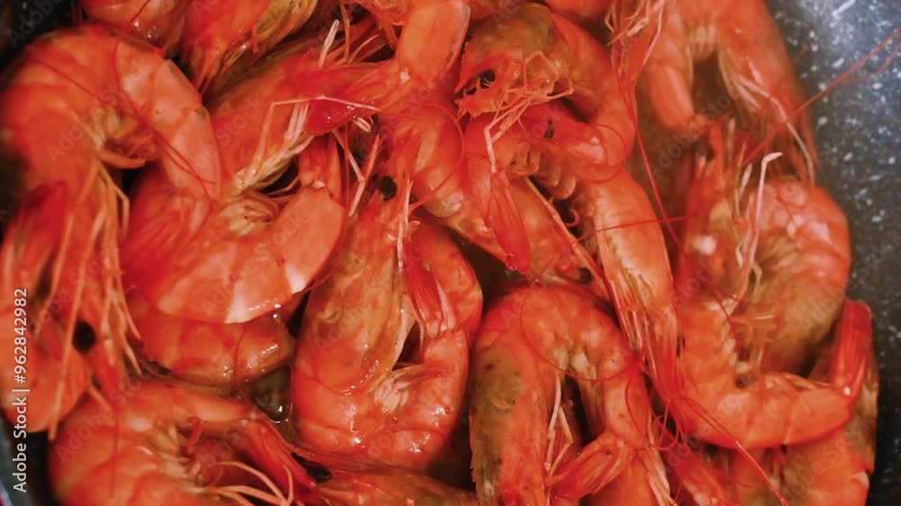 Shrimp fried in oil in a frying pan in close-up. Shrimp fried in oil in a frying pan in close-up.