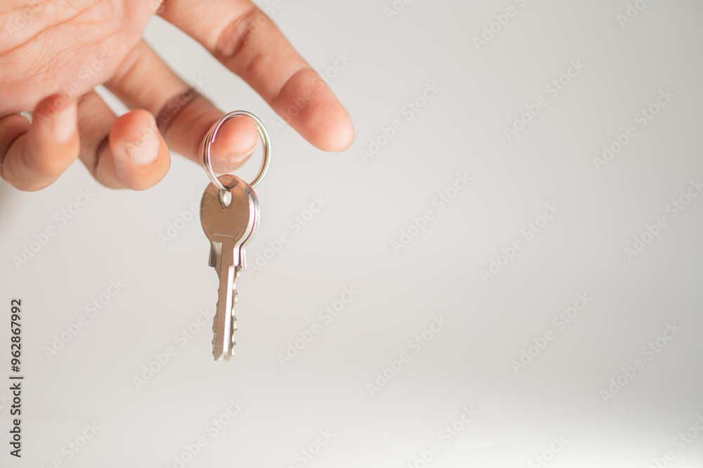 Hand Holding a Key on a Keyring Hand Holding a Key on a Keyring