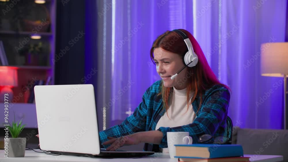 Portrait of cute woman with headset talking in group chat and stressed about losing in online video games, closing laptop and looking at camera sitting in neon light room Portrait of cute woman with headset talking in group chat and stressed about losing in online video games, closing laptop and looking at camera sitting in neon light room