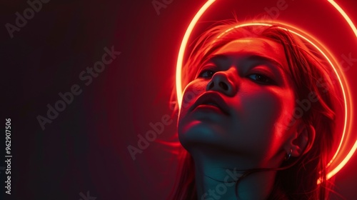 A striking portrait of a woman illuminated by a neon halo. The red and blue lighting creates a dramatic, futuristic atmosphere, highlighting her serene expression and capturing a sense of mystery.