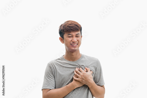 Unhappy young man having heart attack or heart ache isolated on grey background. Concept of people, healthcare and health problems.