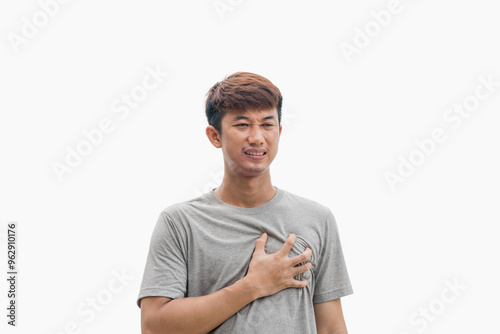 Unhappy young man having heart attack or heart ache isolated on grey background. Concept of people, healthcare and health problems.