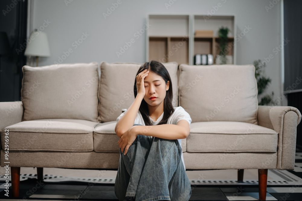 Asian woman sit Depression Dark haired pensive glance Standing by window and anxiety Copy space with a blanket on a sofa. Asian woman sit Depression Dark haired pensive glance Standing by window and anxiety Copy space with a blanket on a sofa.