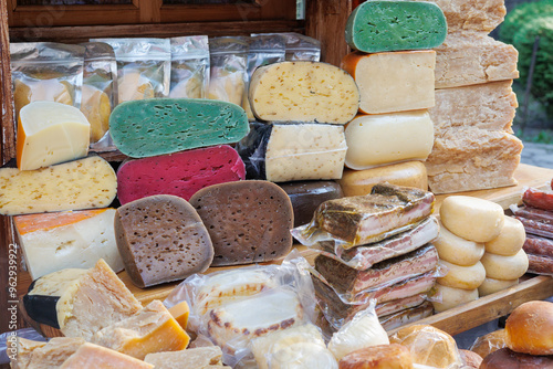 counter with farm colorful cheese. Craft cheeses and sausages - local delicacies, traditional products in the Carpathian village of Yaremche. Healthy food, natural products. Eco products photo