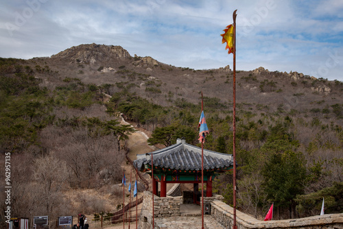 Geumjeong-gu, Busan, South Korea - February 28, 2021: North gate of Geumjeongsanseong Fortress against Godangbong Peak on Geumjeongsan Mountain photo