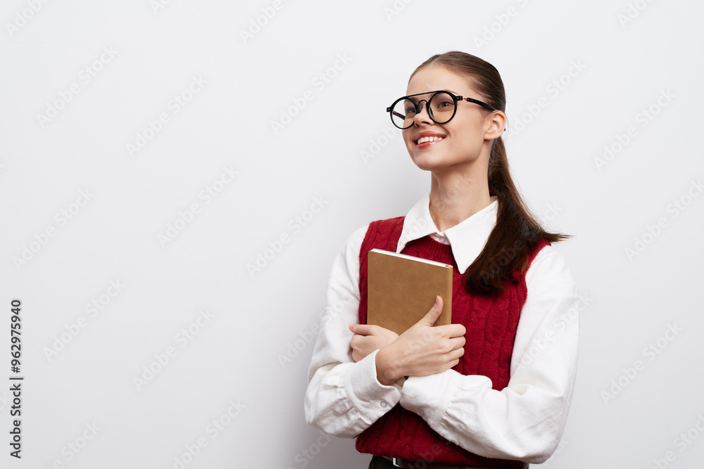 Student smiling with a notebook in hands, wearing glasses on a plain white background, highlighting confidence and academic success Ideal for school or education themes Student smiling with a notebook in hands, wearing glasses on a plain white background, highlighting confidence and academic success Ideal for school or education themes