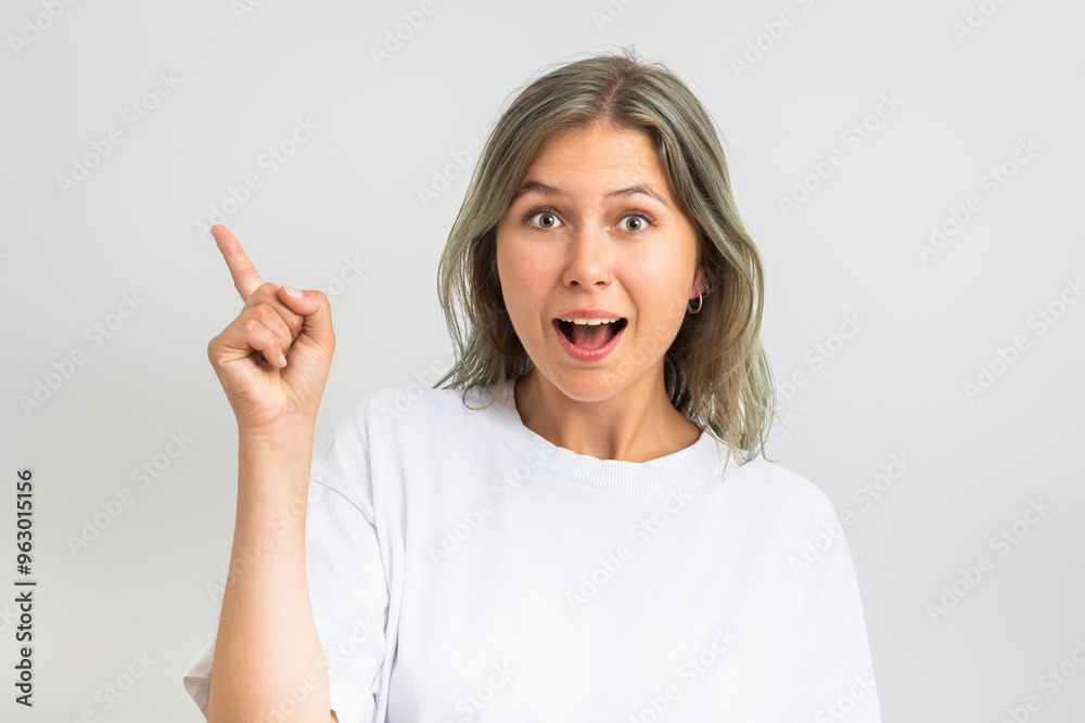 Astonished girl pointing finger at blank copy space. Astonished girl pointing finger at blank copy space.