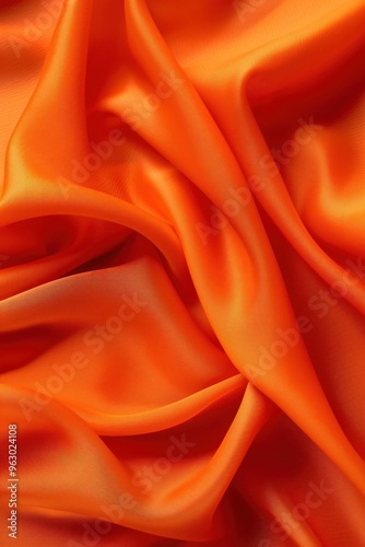 Vibrant orange fabric texture pattern background. Close-up view of orange clothing material with folds creases adding depth dimension. Warm inviting visual with subtle hints red yellow in background.