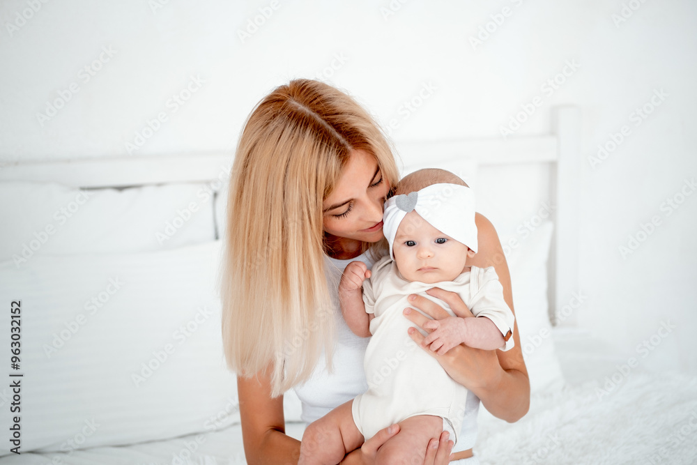 mom and baby hug and kiss, a young mother gently hugs a newborn baby girl holding him in her arms, maternal love and care, a young family, mother and daughter mom and baby hug and kiss, a young mother gently hugs a newborn baby girl holding him in her arms, maternal love and care, a young family, mother and daughter