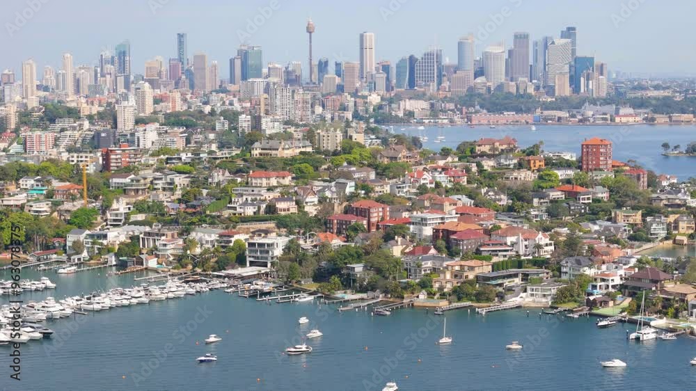 Aerial drone view of the suburb of Point Piper in East Sydney, NSW, Australia in September 2024 showing Sydney City large and prominent in the background with lens compression techniques 
