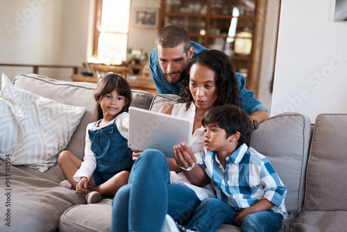 Children, parents and family with tablet on sofa for learning, education or streaming cartoon on internet. Kids, father and mother with technology for movie, games or interracial people relax in home