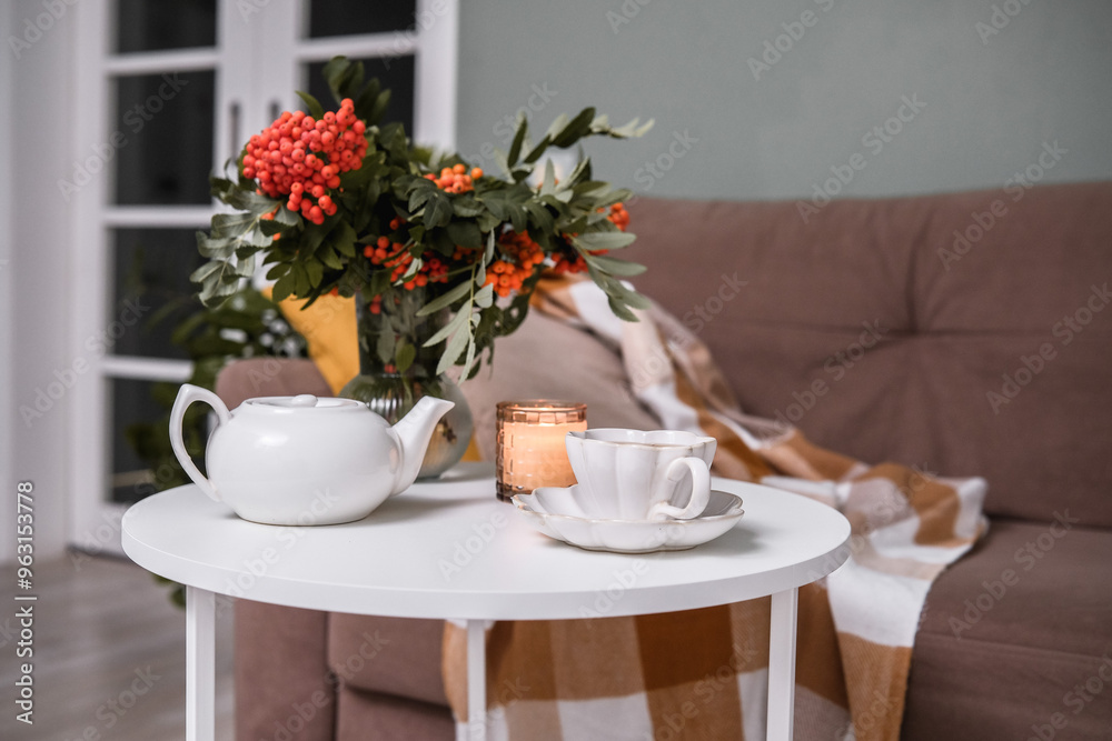 A Cozy Living Room Featuring a Soft Blanket, Lush Green Plants, and a Warm Cup of Coffee A Cozy Living Room Featuring a Soft Blanket, Lush Green Plants, and a Warm Cup of Coffee