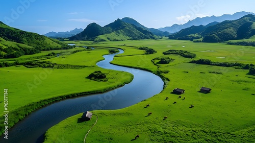 A winding river meanders through a green valley dotted with cows and small houses.