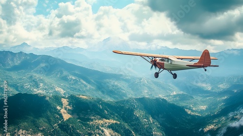 Wallpaper Mural 11. A vintage propeller plane soaring above a mountainous terrain Torontodigital.ca