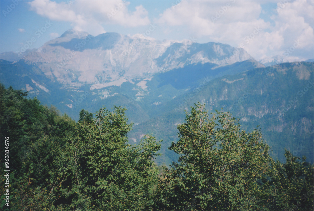 Beautiful View of Mount Krn, in the Julian Alps from Volče Village during a Sunny Summer Day. Soča Valley, Tolmin Province, Slovenia. Film Photography Beautiful View of Mount Krn, in the Julian Alps from Volče Village during a Sunny Summer Day. Soča Valley, Tolmin Province, Slovenia. Film Photography