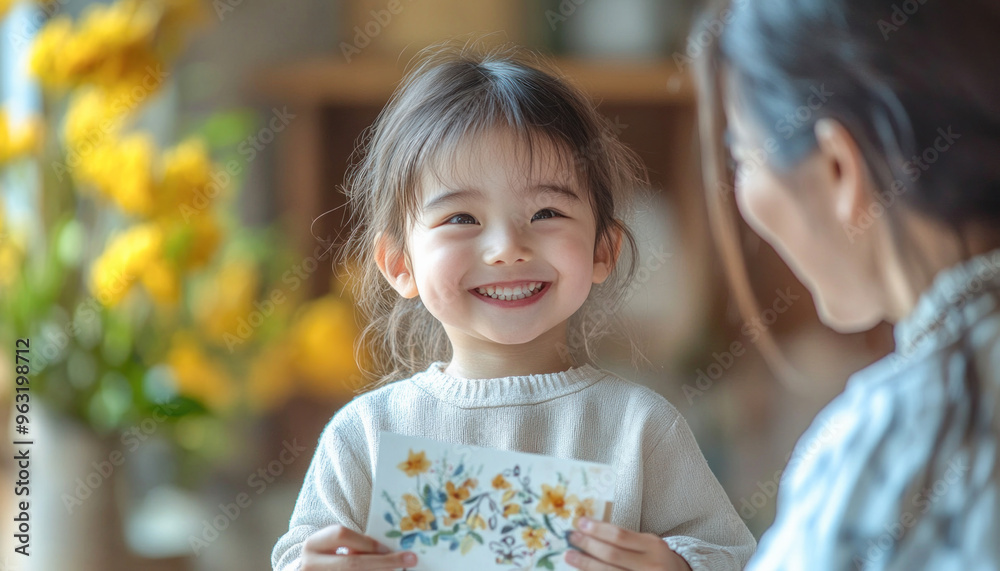 Happy asian girl holding a drawing for her mother Happy asian girl holding a drawing for her mother