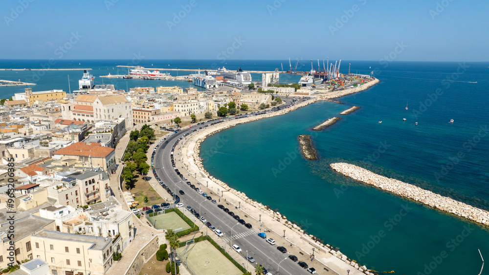 Fototapeta premium Aerial view of the seafront of Bari, Puglia, Italy. There is a road that runs along the sea and the city. The sea is clear despite the proximity of the city.