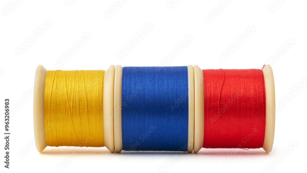 primary colors spool of cotton embroidery sewing thread isolated white background, blue, yellow and red used in detail stitching or decorative fabric and textile industry in different colors primary colors spool of cotton embroidery sewing thread isolated white background, blue, yellow and red used in detail stitching or decorative fabric and textile industry in different colors