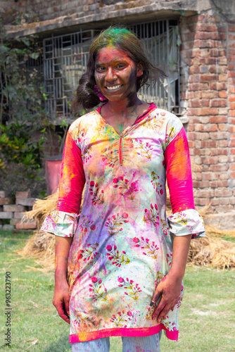 Photography a girl celebrating holi and gulal powder on the face