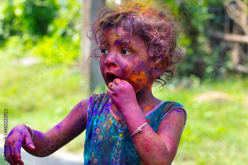 Photography cute girl celebrating holi and gulal powder on the face