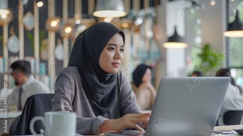 Focused Muslim Businesswoman Working in Collaborative Office Space