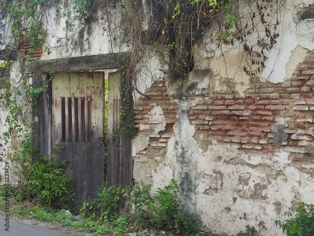 a somewhat neglected old building with peeling walls and an old-fashioned door